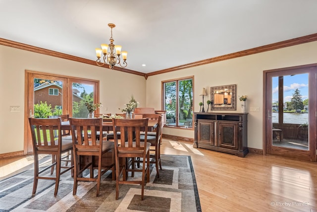 1913 N Woodlawn Park Ave, Mchenry, IL 60051 - dining area with a chandelier, crown molding, and light wood-style floors