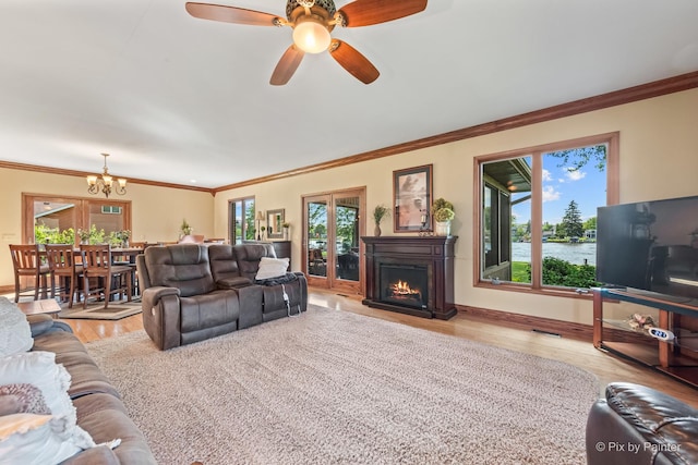 1913 N Woodlawn Park Ave, Mchenry, IL 60051 - living area with a warm lit fireplace, wood finished floors, a chandelier, crown molding, and ceiling fan