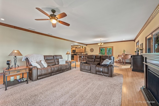 1913 N Woodlawn Park Ave, Mchenry, IL 60051 - living room with light wood-style flooring, a chandelier, ceiling fan, ornamental molding, and a fireplace