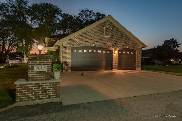 1913 N Woodlawn Park Ave, Mchenry, IL 60051 - view of front of home featuring brick siding, an attached garage, and driveway