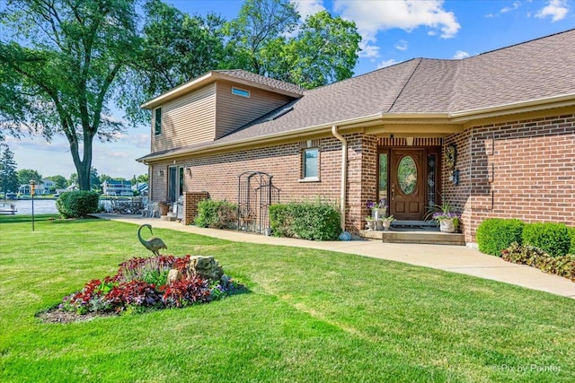 1913 N Woodlawn Park Ave, Mchenry, IL 60051 - view of front of home featuring brick siding, a front yard, and a shingled roof