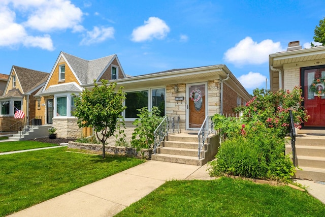7004 W School St, Chicago, IL 60634 - view of front facade with brick siding, a front yard, and stone siding