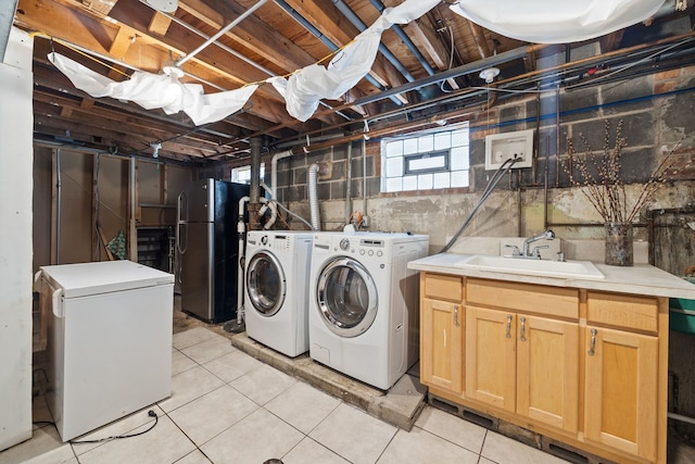 7004 W School St, Chicago, IL 60634 - washroom featuring washing machine and clothes dryer, cabinet space, and light tile patterned flooring