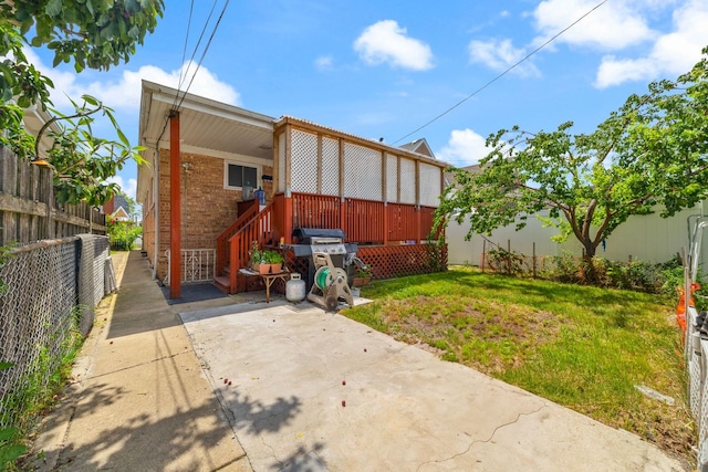 7004 W School St, Chicago, IL 60634 - rear view of house with brick siding and a fenced backyard
