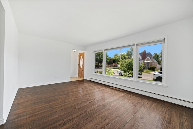 7004 W School St, Chicago, IL 60634 - empty room with wood finished floors and a baseboard radiator