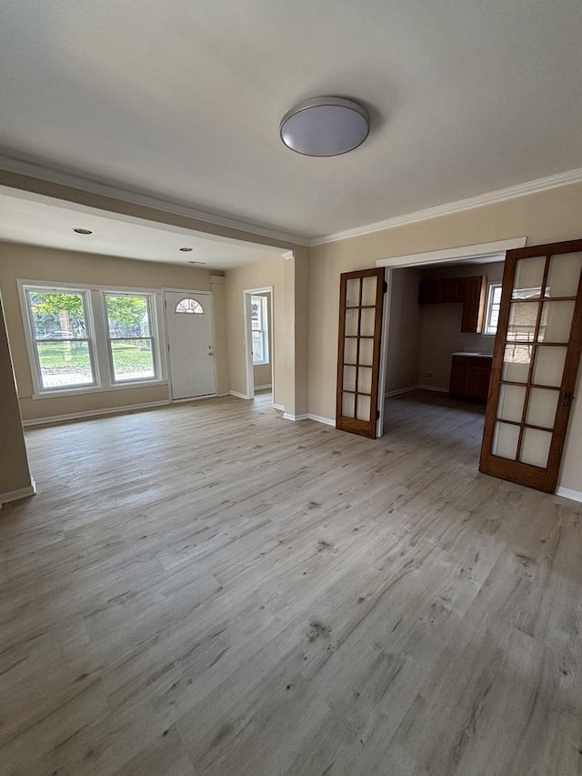 6638 S Albany Ave, Chicago, IL 60629 - unfurnished living room featuring light wood-style floors, healthy amount of natural light, and ornamental molding