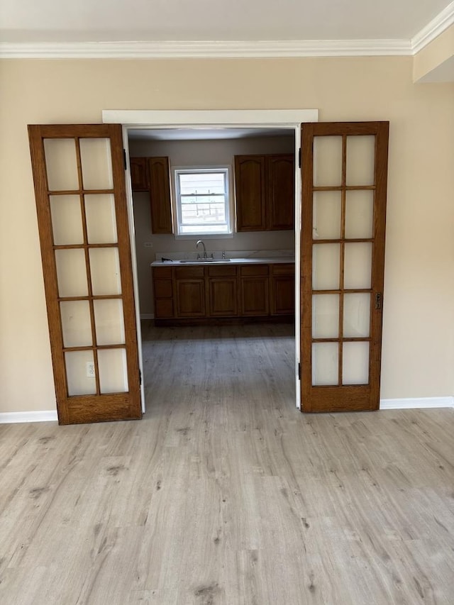 6638 S Albany Ave, Chicago, IL 60629 - kitchen with light wood-style floors, ornamental molding, light countertops, and brown cabinets