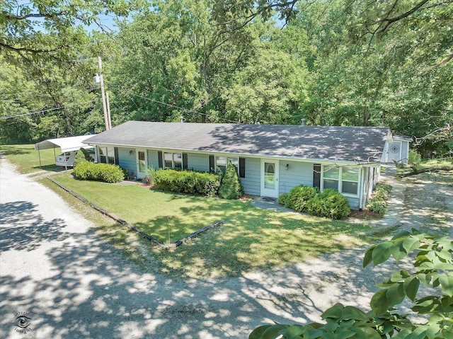 555/557 W Bluff St, Marseilles, IL 61341 - ranch-style home with gravel driveway, a detached carport, and a front yard