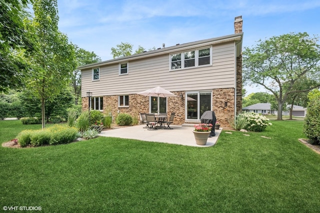 1355 W Kenilworth Ave, Palatine, IL 60067 - back of property featuring a chimney, a lawn, brick siding, and a patio area
