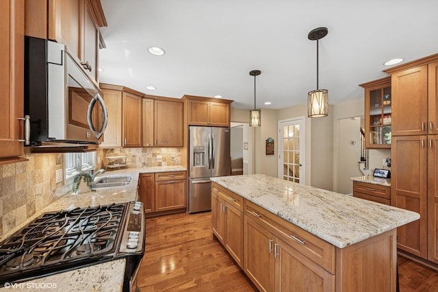 1355 W Kenilworth Ave, Palatine, IL 60067 - kitchen featuring stainless steel appliances, wood finished floors, a kitchen island, brown cabinets, and recessed lighting