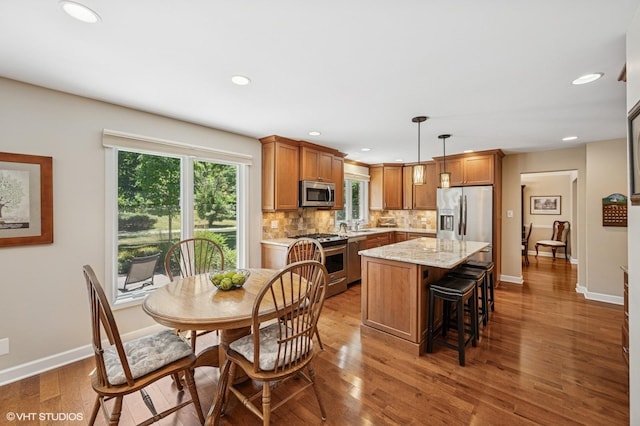 1355 W Kenilworth Ave, Palatine, IL 60067 - kitchen with stainless steel appliances, wood finished floors, brown cabinets, tasteful backsplash, and recessed lighting