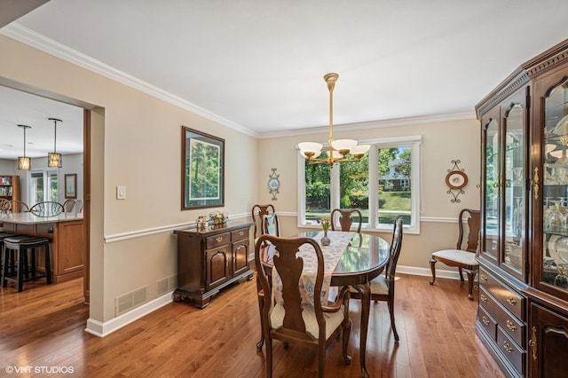 1355 W Kenilworth Ave, Palatine, IL 60067 - dining room with a chandelier, light wood-style floors, and ornamental molding