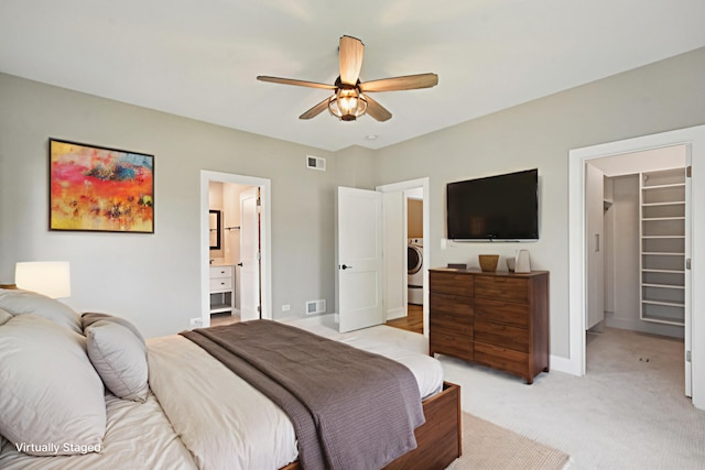 220 S Primrose Dr, Coal City, IL 60416 - bedroom featuring a spacious closet, washer / dryer, light carpet, ceiling fan, and ensuite bath