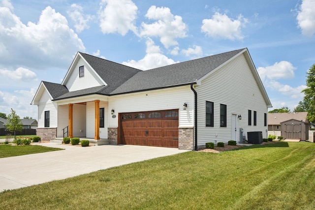 220 S Primrose Dr, Coal City, IL 60416 - modern inspired farmhouse featuring a garage, driveway, a front yard, a shingled roof, and a storage shed