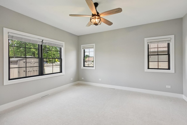 220 S Primrose Dr, Coal City, IL 60416 - empty room featuring carpet, plenty of natural light, and a ceiling fan