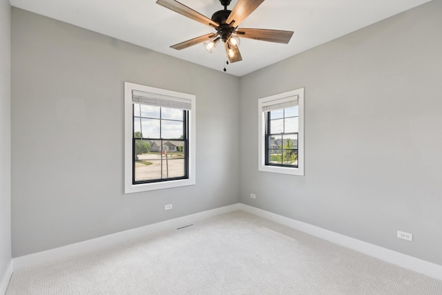 220 S Primrose Dr, Coal City, IL 60416 - empty room with plenty of natural light, light colored carpet, and a ceiling fan