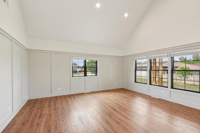 220 S Primrose Dr, Coal City, IL 60416 - spare room with a decorative wall, high vaulted ceiling, and light wood finished floors