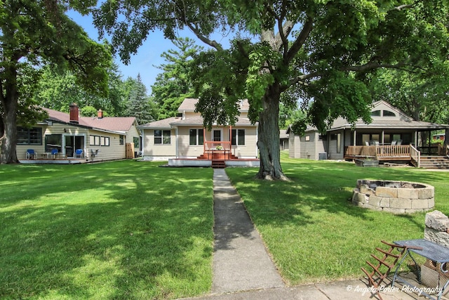 312 Country Club Dr, Mchenry, IL 60050 - view of green lawn featuring a wooden deck and a fire pit