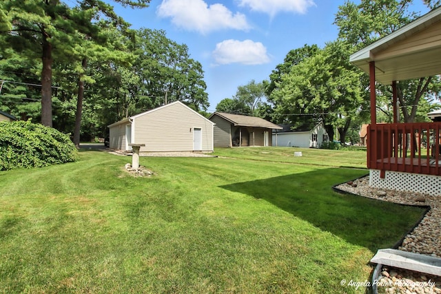 312 Country Club Dr, Mchenry, IL 60050 - view of grassy yard featuring a wooden deck and an outbuilding