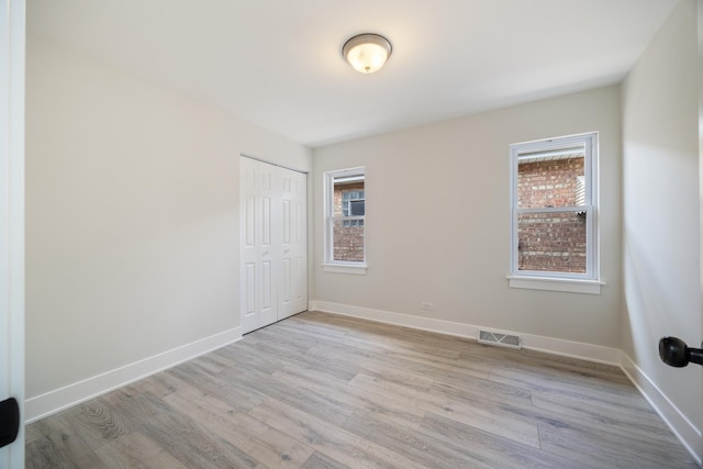 8858 S Calumet Ave, Chicago, IL 60619 - spare room with healthy amount of natural light and light wood finished floors