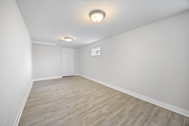8858 S Calumet Ave, Chicago, IL 60619 - empty room with light wood finished floors and baseboards