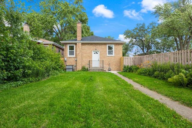 8858 S Calumet Ave, Chicago, IL 60619 - rear view of property featuring brick siding and a chimney