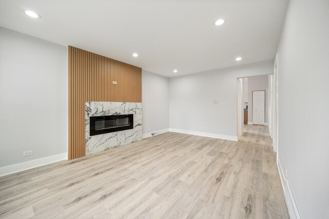 8858 S Calumet Ave, Chicago, IL 60619 - unfurnished living room with light wood-style flooring, recessed lighting, and a fireplace