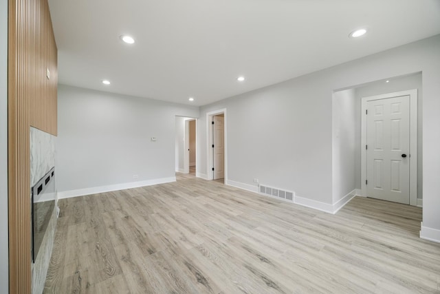 8858 S Calumet Ave, Chicago, IL 60619 - unfurnished living room featuring light wood finished floors, recessed lighting, and a high end fireplace