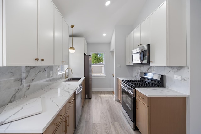 8858 S Calumet Ave, Chicago, IL 60619 - kitchen with stainless steel appliances, tasteful backsplash, light stone counters, light wood-type flooring, and recessed lighting