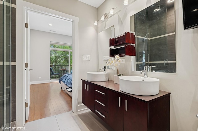 3516 N Ashland Ave N Unit 3S, Chicago, IL 60657 - ensuite bathroom featuring double vanity, wood finished floors, and a shower with door