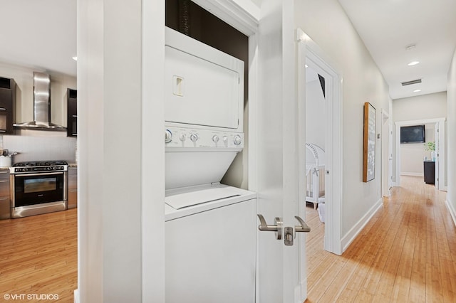 3516 N Ashland Ave N Unit 3S, Chicago, IL 60657 - laundry room featuring stacked washer and clothes dryer, light wood-type flooring, and recessed lighting