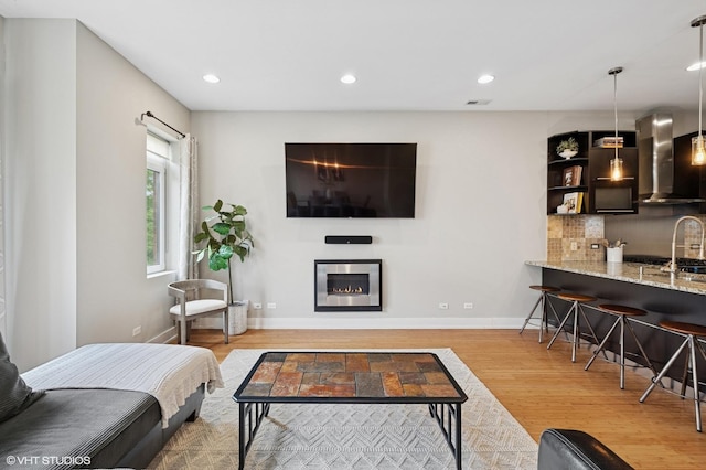 3516 N Ashland Ave N Unit 3S, Chicago, IL 60657 - living area featuring wood finished floors, recessed lighting, and a glass covered fireplace