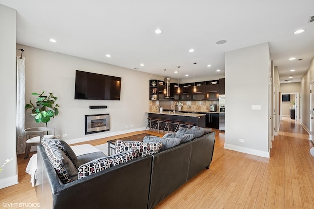 3516 N Ashland Ave N Unit 3S, Chicago, IL 60657 - living area with light wood-type flooring, recessed lighting, and a glass covered fireplace