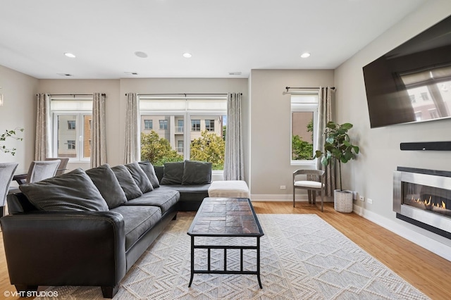 3516 N Ashland Ave N Unit 3S, Chicago, IL 60657 - living area featuring plenty of natural light, wood finished floors, recessed lighting, and a glass covered fireplace