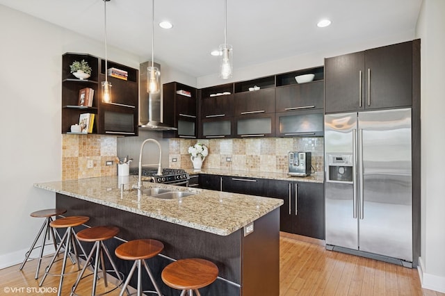 3516 N Ashland Ave N Unit 3S, Chicago, IL 60657 - kitchen with built in refrigerator, open shelves, wall chimney exhaust hood, a peninsula, and a kitchen bar