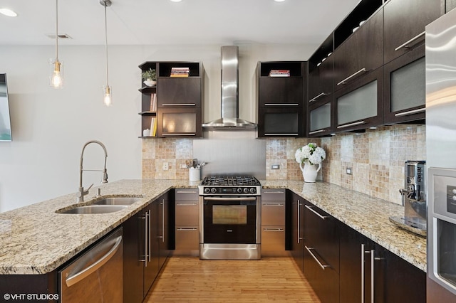 3516 N Ashland Ave N Unit 3S, Chicago, IL 60657 - kitchen with wall chimney range hood, appliances with stainless steel finishes, light wood-type flooring, a peninsula, and decorative backsplash