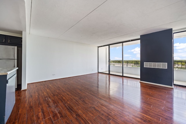 2005 S Finley Rd Unit 1204, Lombard, IL 60148 - unfurnished living room with dark wood finished floors and a wall of windows