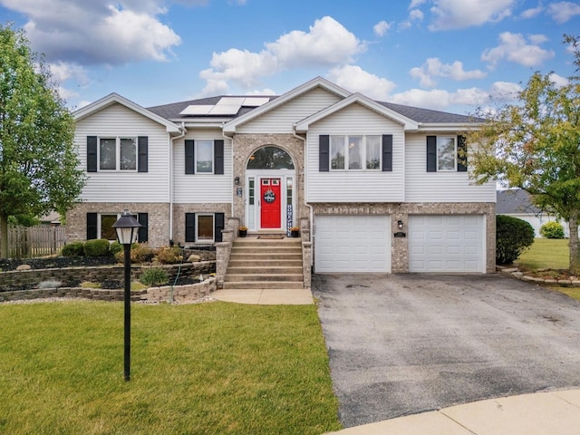 5147 Fairground Ct, Monee, IL 60449 - raised ranch featuring driveway, solar panels, a garage, and brick siding