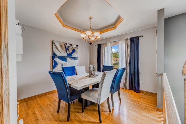 5147 Fairground Ct, Monee, IL 60449 - dining area featuring a tray ceiling, a chandelier, and light wood-style flooring