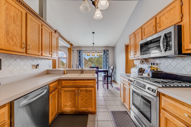 5147 Fairground Ct, Monee, IL 60449 - kitchen with appliances with stainless steel finishes, a chandelier, lofted ceiling, light tile patterned floors, and backsplash