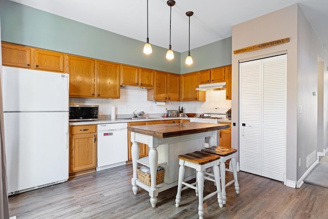 21549 Fulton Ct, Plainfield, IL 60544 - kitchen with white appliances, wood counters, under cabinet range hood, backsplash, and wood finished floors