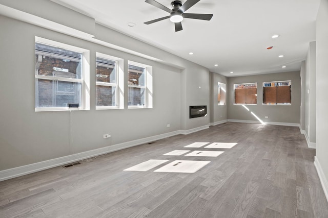 7711 S Ridgeland Ave, Chicago, IL 60649 - unfurnished living room featuring ceiling fan, wood finished floors, plenty of natural light, and recessed lighting