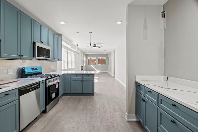 7711 S Ridgeland Ave, Chicago, IL 60649 - kitchen with appliances with stainless steel finishes, a peninsula, a ceiling fan, light wood finished floors, and hanging light fixtures