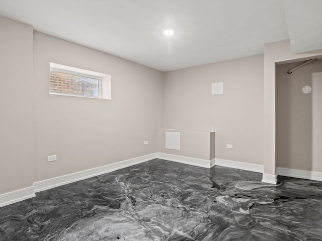 7711 S Ridgeland Ave, Chicago, IL 60649 - below grade area with baseboards and dark marble finish floors