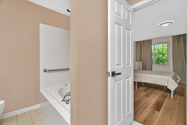 16636 Winding Creek Rd, Plainfield, IL 60586 - bathroom featuring tiled tub and tile patterned flooring