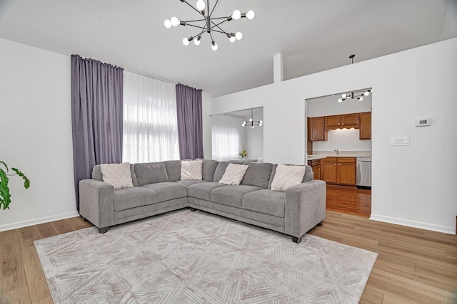 16636 Winding Creek Rd, Plainfield, IL 60586 - living room featuring a chandelier, light wood finished floors, and vaulted ceiling