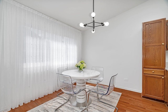 16636 Winding Creek Rd, Plainfield, IL 60586 - dining area with a chandelier and light wood-type flooring