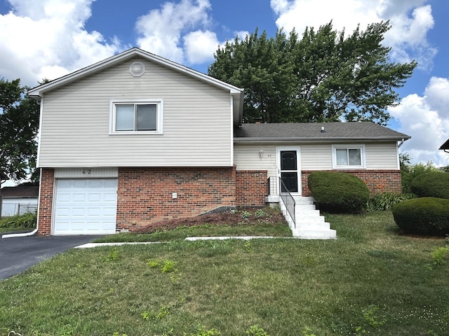 42 Pheasant Rd, Matteson, IL 60443 - tri-level home featuring brick siding, a front yard, driveway, and a garage