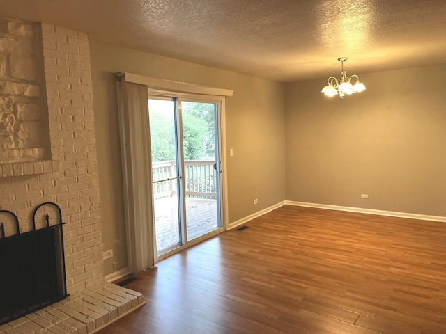 42 Pheasant Rd, Matteson, IL 60443 - unfurnished living room with wood finished floors, a textured ceiling, and a chandelier