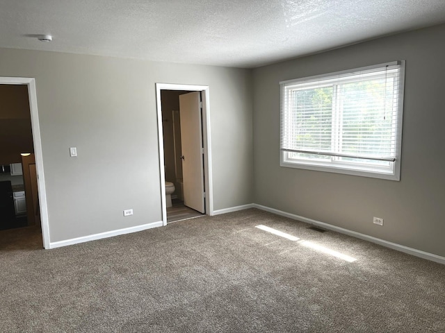 42 Pheasant Rd, Matteson, IL 60443 - unfurnished bedroom with carpet flooring, a textured ceiling, and ensuite bathroom